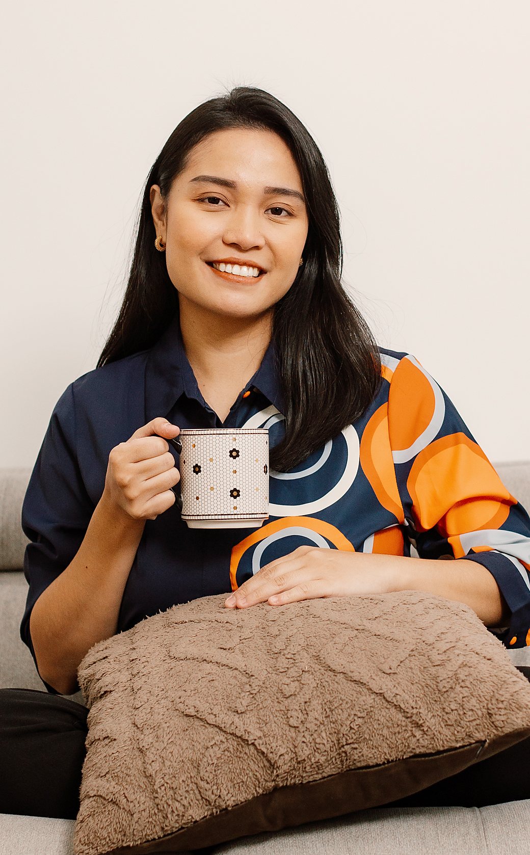 Sarah Lagrosa at home, holding a mug of coffee